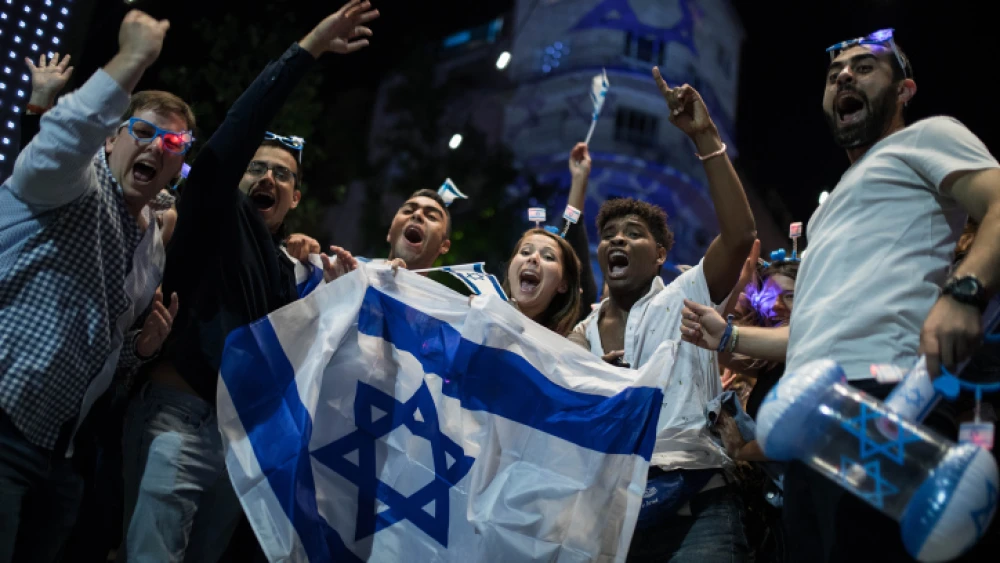 People wear Israeli flags as they take part in celebrations marking Israel's 71st Independence Day in Jerusalem on May 8, 2019. Photo by Hadas Parush/Flash90.