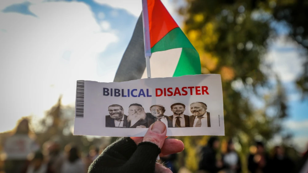 Palestinians protest against the evacuation of squatters from the eastern Jerusalem neighborhood of Sheikh Jarrah with a sign denigrating Jewish history and the Israeli government, Jan. 13, 2023. Photo by Jamal Awad/Flash90.