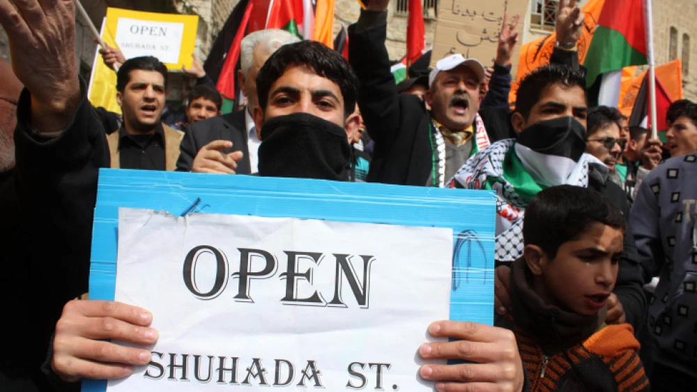Palestinians during a demonstration against the closure of Shuhada Street in the West Bank city of Hebron on Feb. 25, 2011. Photo by Najeh Hashlamoun/Flash90.