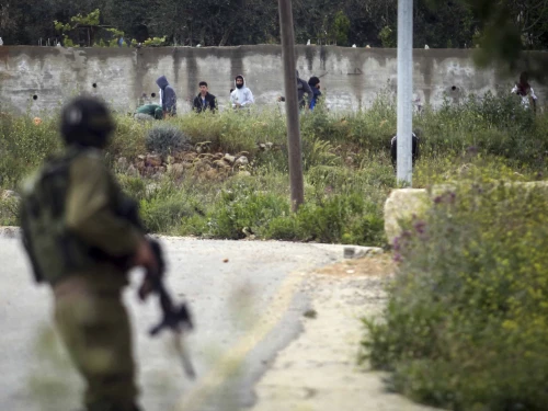 Palestinian terrorists throw rocks towards Israeli security forces in the Samaria village of Sinjil, April 13, 2015. Photo by STR/Flash90.