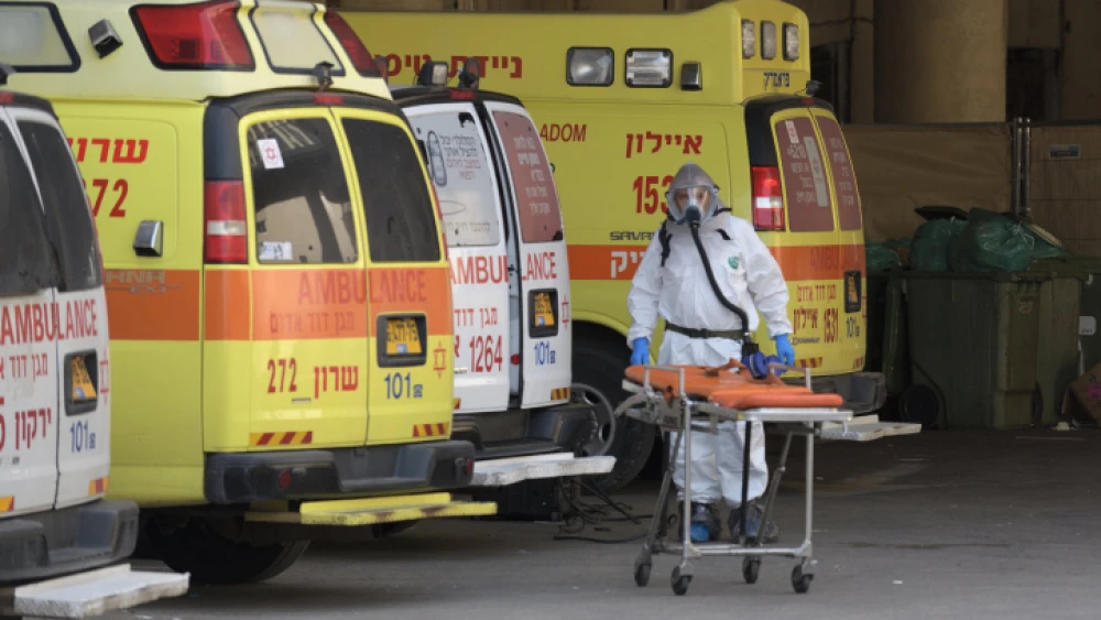 An Israeli medical team member clean and disinfect an ambulance at Tel Aviv's Dan Panorama hotel, which was turned into quarantine facility for coronavirys patients, on March 26, 2020. Photo by Gili Yaari/Flash90.