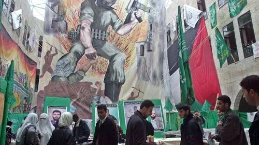 Palestinian students visit an exhibit for the terror group Hamas at An-Najah University Jan. 28, 2002 in the West Bank town of Nablus. Credit: CAM99/Getty Images.