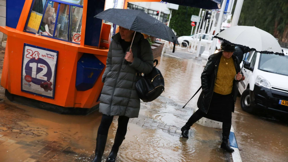 Women walk in the northern Israeli city of Nahariya, a day after serious flooding, on Jan. 9, 2020. Photo by David Cohen/Flash90.