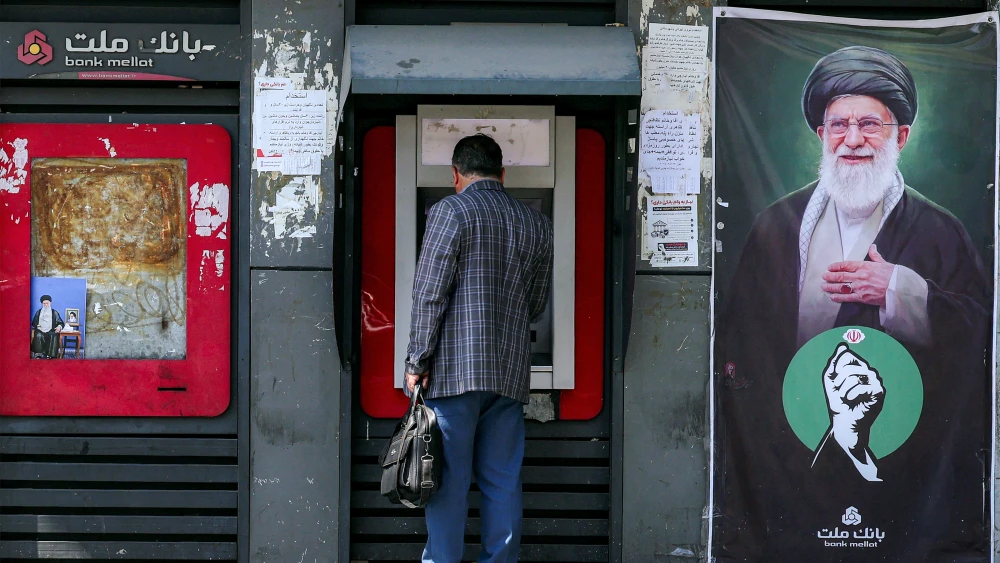 A man uses an ATM at Bank Mellat in Tehran on Sept. 7, 2026. Photo by AFP via Getty Images.