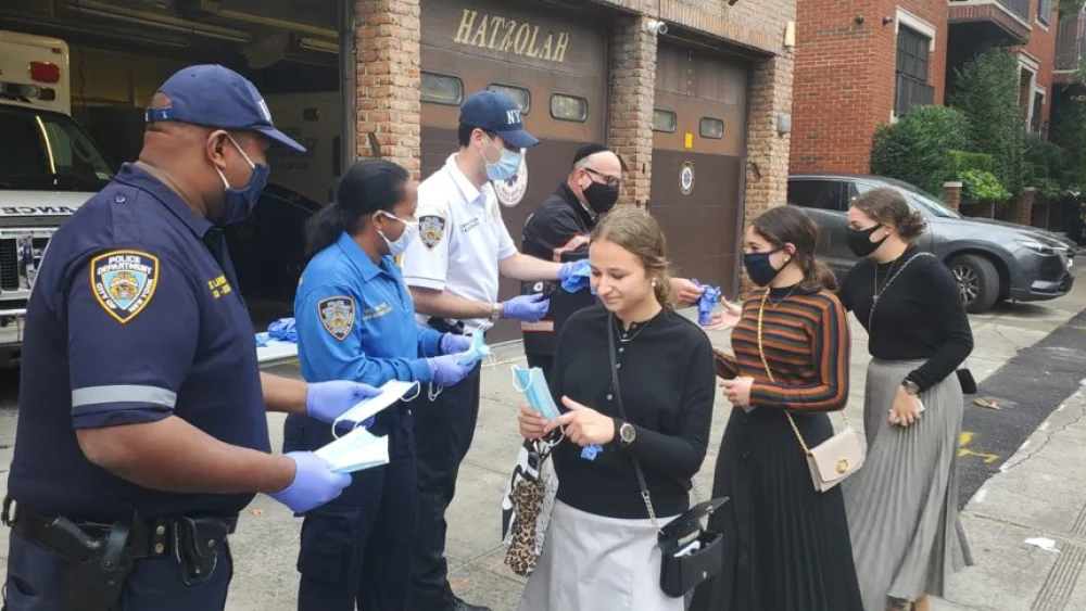 New York Police Department and Hatzolah of Boro Park distributing masks to the local Jewish community. Credit: NYPD via Twitter.