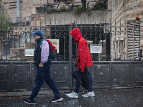 People walk in the rain in Jerusalem, on Nov. 25, 2025. Photo by Yonatan Sindel/Flash90.