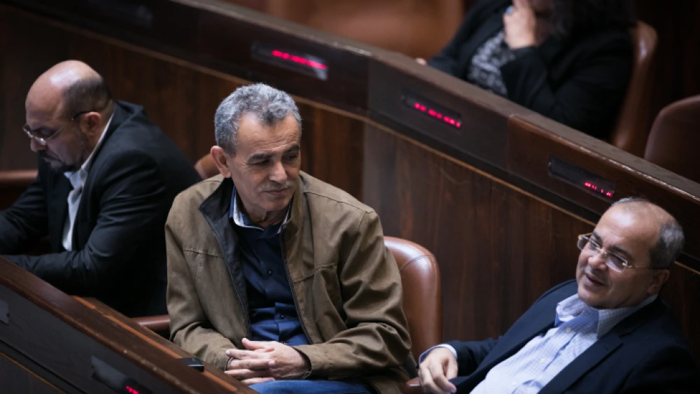 Joint Party Knesset members Jamal Zahalka (center) and Ahmad Tibi (right) attend a plenum session in the assembly hall of the Israeli parliament on Dec. 5, 2016. Photo by Yonatan Sindel/Flash90.