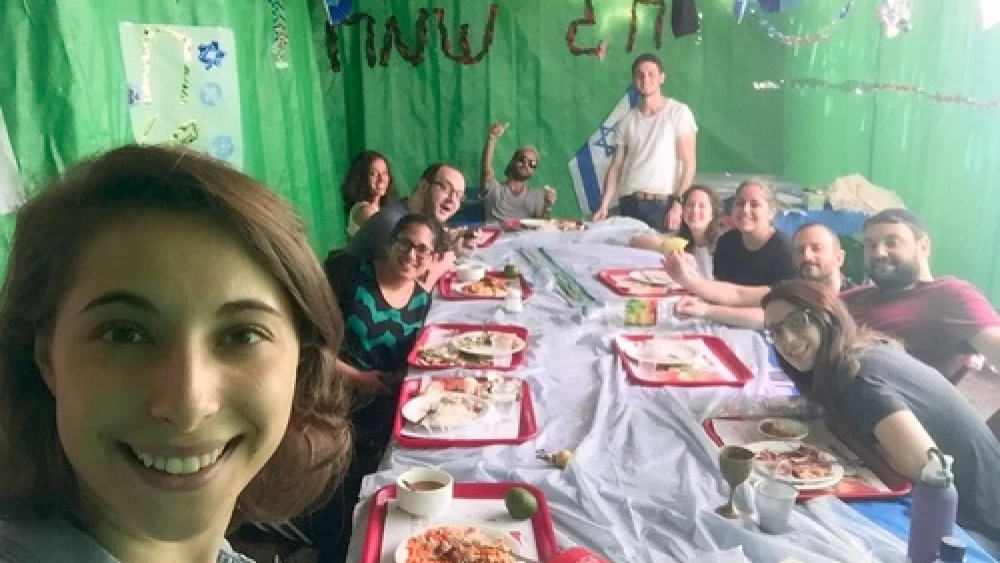 Click photo to download. Caption: Eliana Rudee in the sukkah with her ulpan classmates. Credit: Courtesy Eliana Rudee.