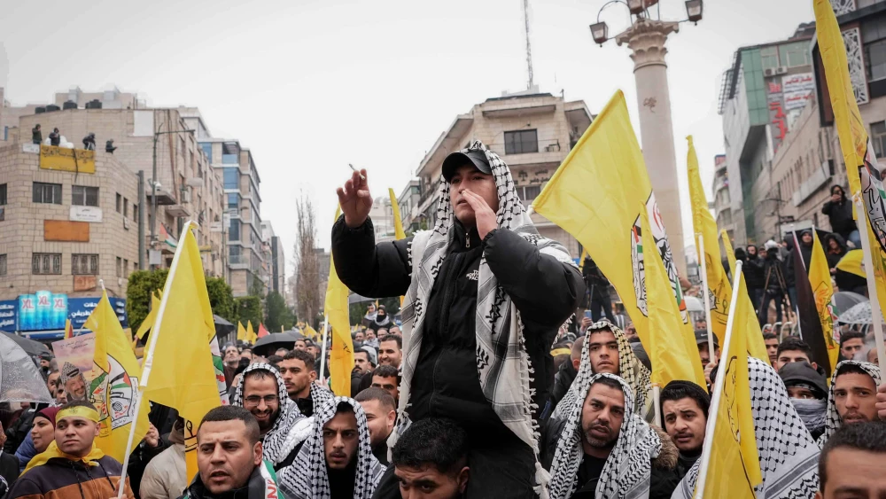 Fatah supporters gather for a rally ahead of the 60th anniversary of its establishment in Ramallah, Samaria