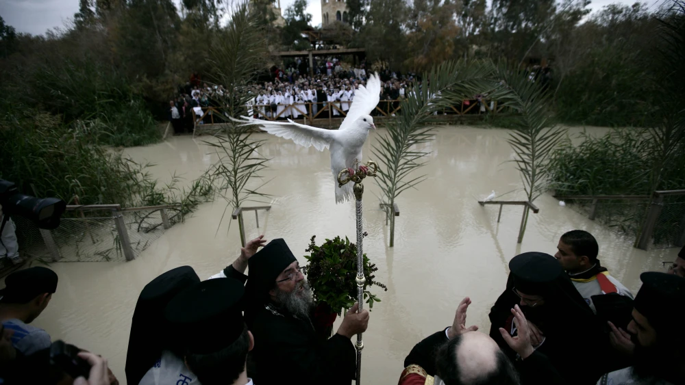 Greek Orthodox Patriarch of Jerusalem Metropolitan Theophilos (center) leads a ceremony at the baptismal site known as Qasr el-Yahud on the Jordan River near the West Bank city of Jericho, Jan. 18, 2010. Orthodox Christians flocked to the Jordan River to celebrate the feast of the Epiphany at the traditional site where it is believed John the Baptist baptised Jesus Christ. Credit: Abir Sultan/Flash 90.
