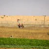 Palestinians wave a flag near the border fence east of Kahn Yunis in the southern Gaza Strip, on May 19, 2017. Credit: Abed Rahim Khatib/ Flash90.