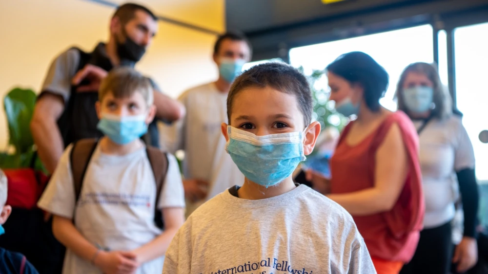A boy arrives with his family in Israel on May 20, 2020, after delays due to the global coronavirus pandemic. They were brought over by the International Fellowship of Christians and Jews. Photo by Arik Shraga.