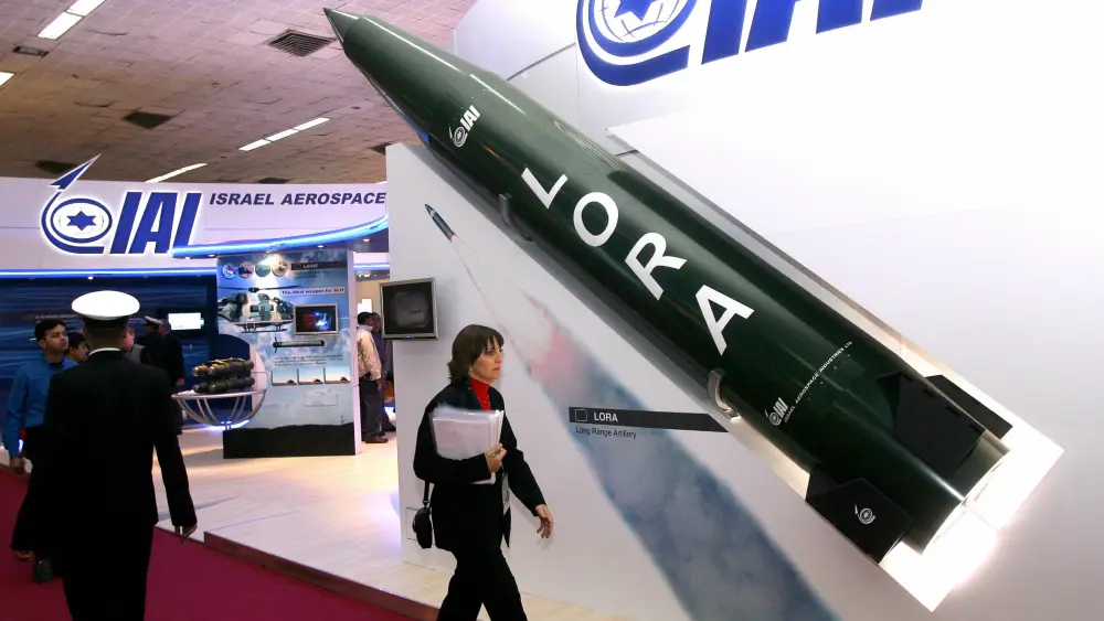 A woman walks past a model of a LORA (Long-Range Artillery Weapon System) missile at the Israeli pavilion during the DefExpo India defense exhibition in New Delhi, Feb. 16, 2008. Photo by Raveendran/AFP via Getty Images.