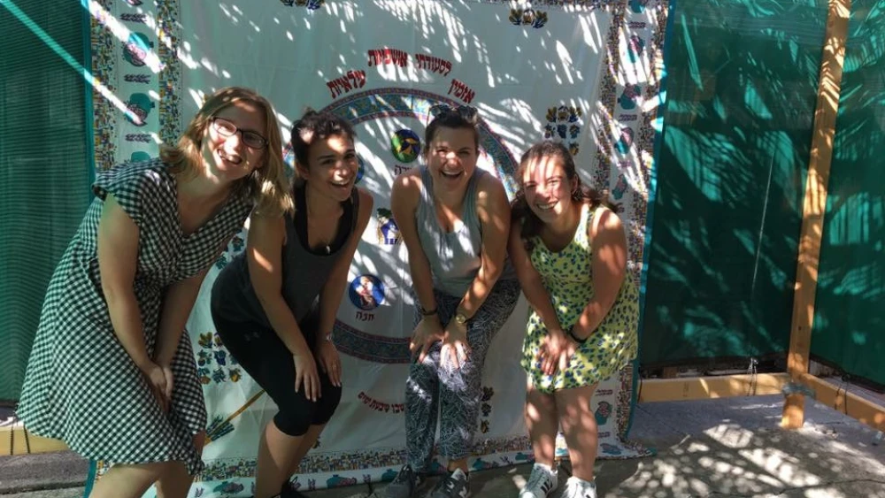 Ariel Starr, 20, from the University of California, Berkeley (second from left) and a few other JLF students under a sukkah they built with their facilitator. Courtesy.