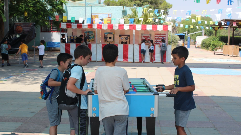 Boys relax and engage in a game of foosball at Yuvalei Ha-Bsor School camp. Photo by Eric Narrow/JNF.