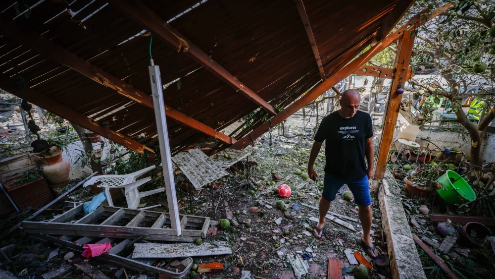 A man examines damage to a home in the Haifa bayside suburb of Kiryat Bialik, Sept. 22, 2024. Photo by Chaim Goldberg/Flash90.