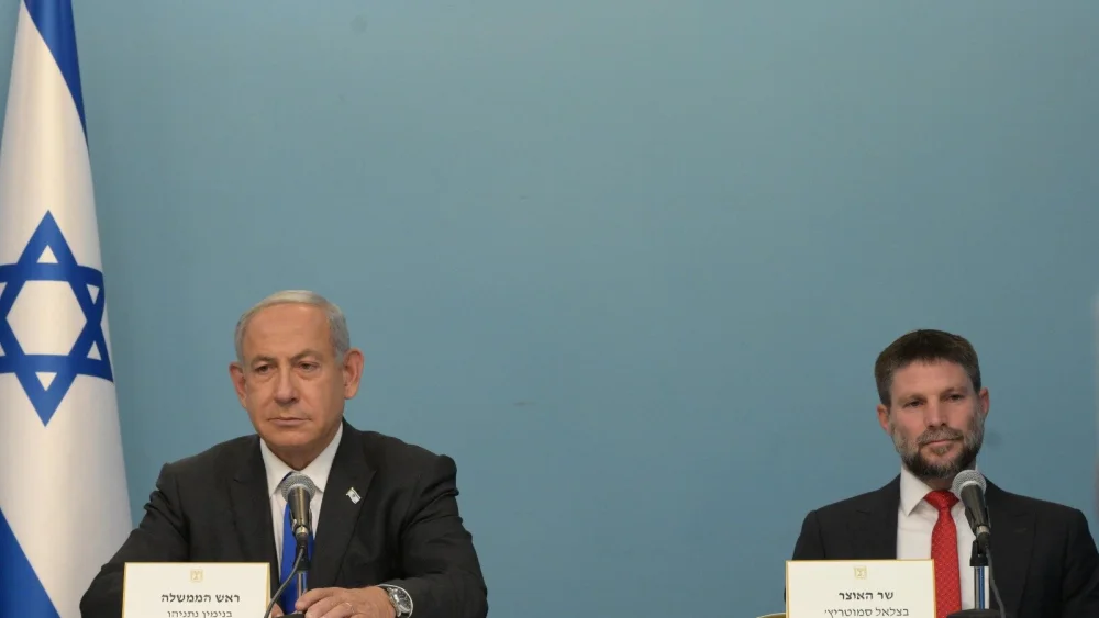 Israeli Prime Minister Benjamin Netanyahu (left) and Israeli Finance Minister Bezalel Smotrich unveil new economic measures to curb the rising cost of living in Israel, on Jan. 11, 2023. Credit: Amos Ben-Gershom/GPO.