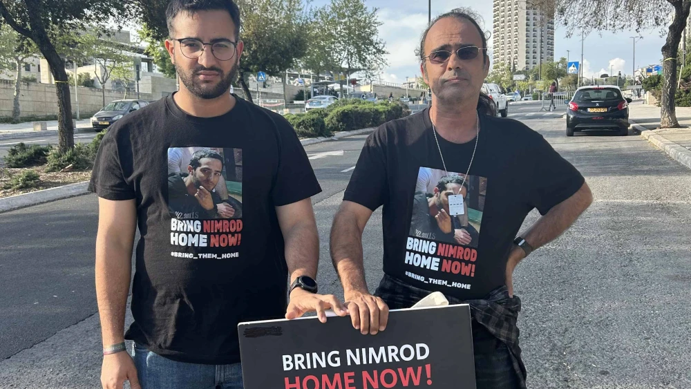 Yotam and Yehuda Cohen, the brother and father of IDF soldier Nimrod Cohen, who was kidnapped near Kibbutz Nirim on Oct. 7, prepare for rally in Jerusalem, April 7, 2024. Photo by Amelie Botbol.