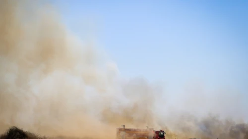 Firefighters work to contain a blaze near Kibbutz Be'eri, near the border with the Gaza Stip, caused by incendiary kites launched from Gaza, Aug. 11, 2020. Photo by Flash90.
