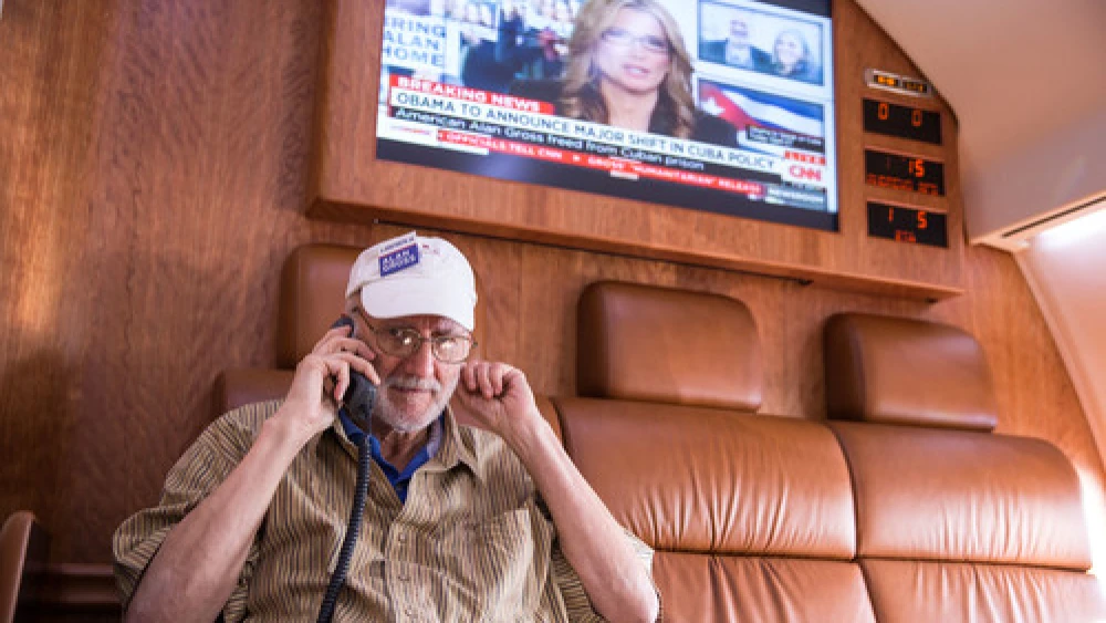 After being released from prison in Cuba, Alan Gross speaks on the phone with President Barack Obama during his flight back to the U.S. on Dec. 17. Credit: White House.