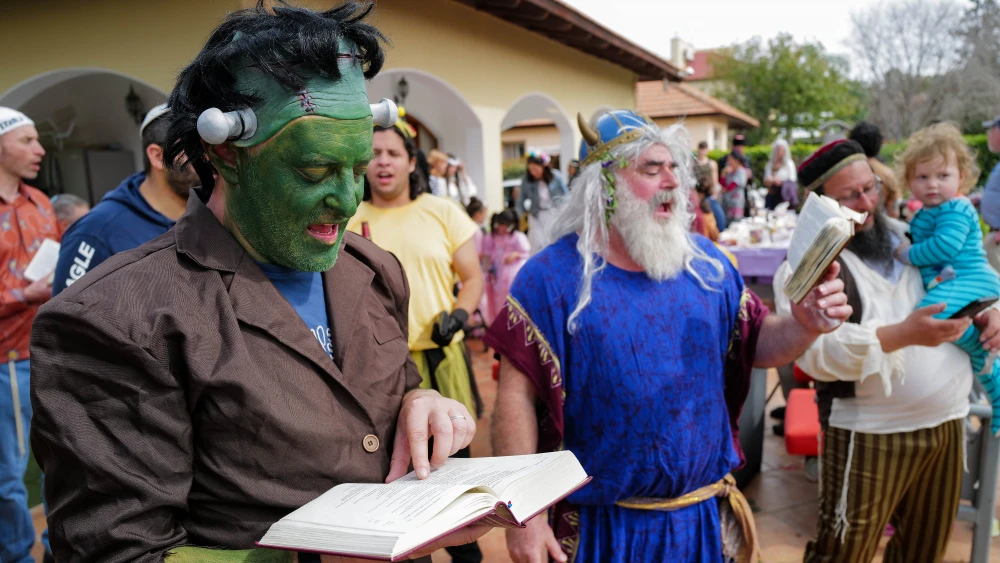 Jews, some of them new immigrants read the Megillat Esther (the Story of Esther) during the Jewish holiday of Purim, in Katzrin in northern Israel on March 7, 2023. Photo by Michael Giladi/Flash90.