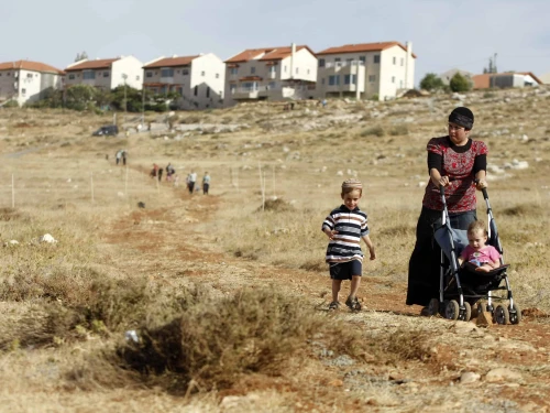 A woman and her children walk towards the town of Kochav HaShahar in the Binyamin region of Samaria, June 4, 2009. Photo by Abir Sultan /Flash90.