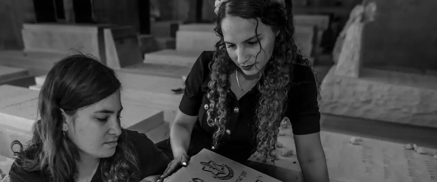 Tehila Mark and her sister, Orit Mark-Ettinger, at the graveside of their brother, IDF Lt. Pedayah Mark, in Jerusalem, Sept. 24, 2026. Photo by Rina Castelnuovo.