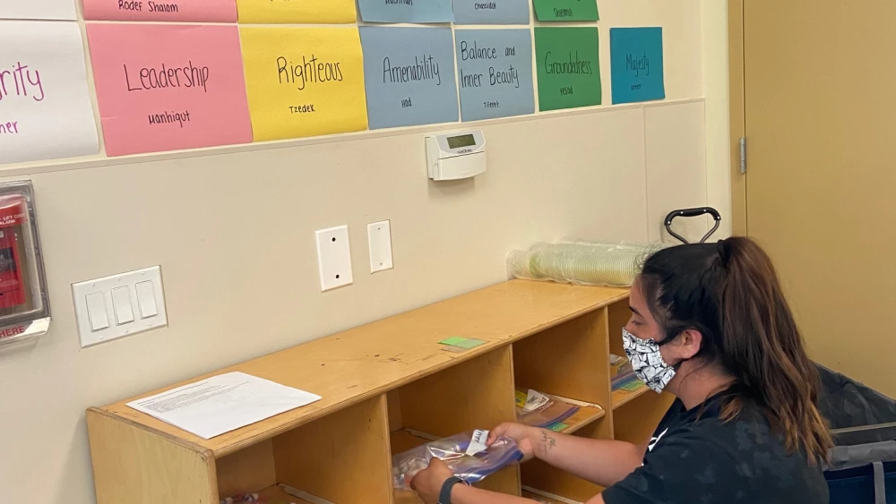 J-Camp counselor Emily Randall gets ready to welcome campers with individualized supply kits and camp values. Credit: Courtesy.