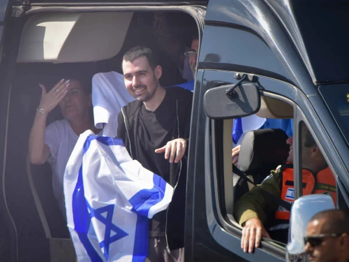 Released hostage Guy Gilboa-Dalal waves the Israeli flag as he arrives to Beilinson hospital, Oct. 13, 2025. Photo by Avshalom Sassoni/Flash90.