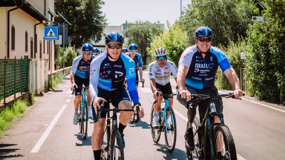 Sharon Shevo (left), Avida Bachar (right) and Sylvan Adams (behind Bachar) take part in a training session with the team ahead of the Tour de France. Credit: Israel-Premier Tech.