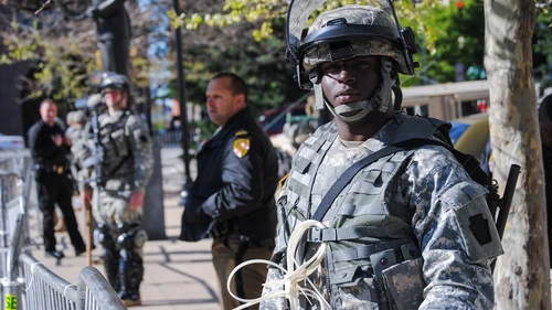 Click photo to download. Caption: A Maryland National Guard soldier keeps watch in front of Baltimore City Hall on April 28 to help deter violence in that area. Credit: Staff Sgt. Ron Lee, 29th Mobile Public Affairs Detachment.