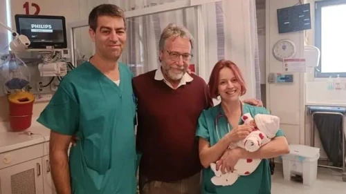 Tamar Levi's daughter with Dr. Shay Porat (left), Dr. Marc Zerah (center) and another medical staffer. Credit: Hadassah Spokesperson.