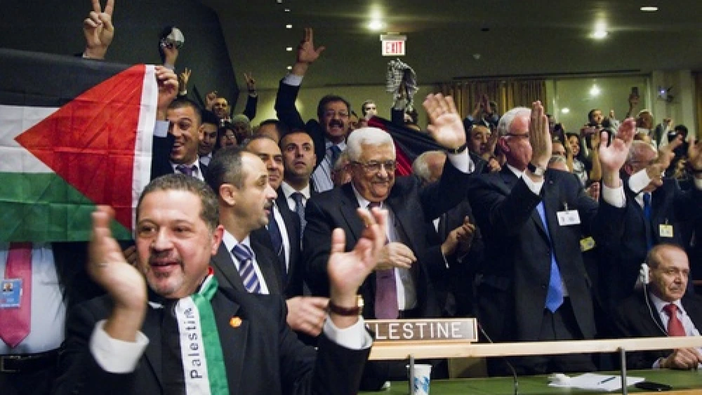 Members of the Palestinian delegation at the United Nations General Assembly celebrate on Nov. 29, 2012, upon the vote to upgrade Palestinian status to a nonmember observer state in the U.N. Credit: UN/Rick Bajornas.