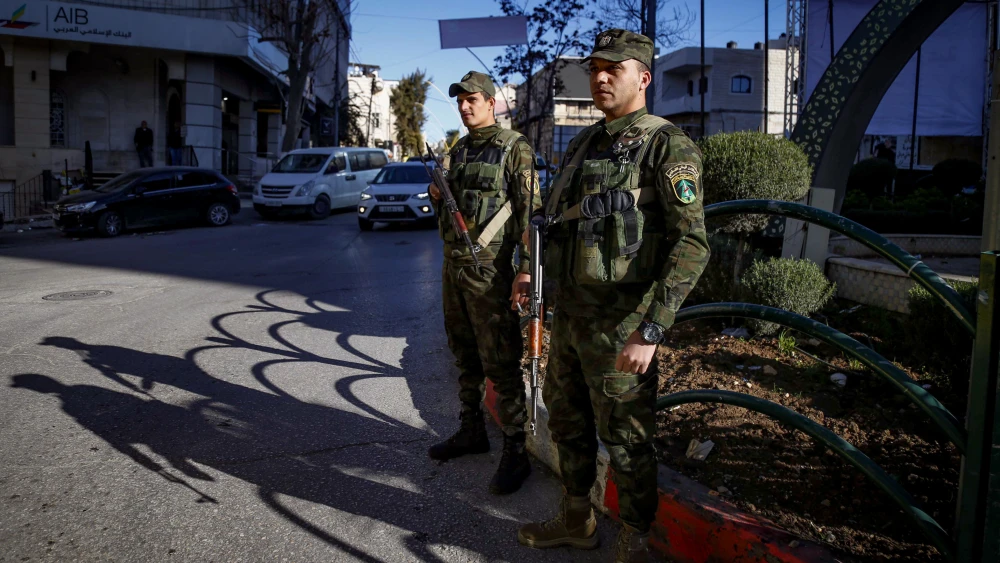 Members of the Palestinian security forces guard in the West Bank city of Hebron, December 24, 2024.