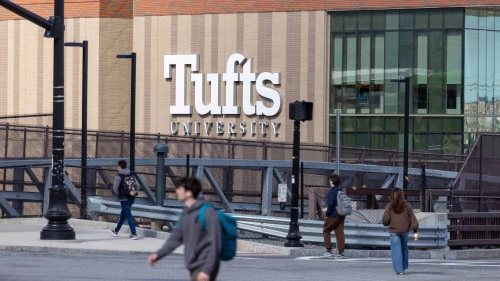 People walk on College Avenue near Tufts University in Medford, Mass., on March 27, 2025. Photo by Scott Eisen/Getty Images.