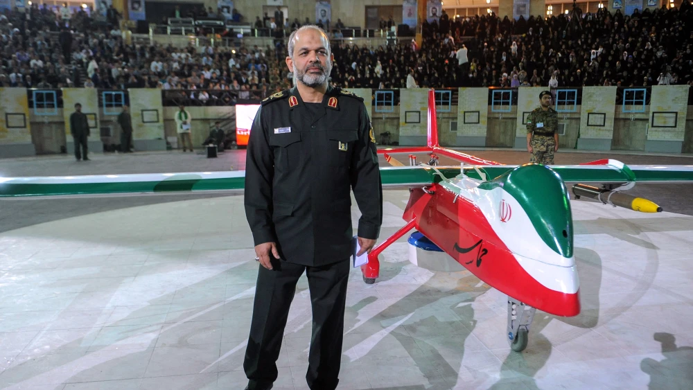 Iranian Defense Minister Ahmad Vahidi stands next to the new Iranian-made drone “Epic,” a stealth model, during a ceremony in Tehran on May 9, 2013. Photo by Hemmat Khahi/ISNA News Agency/AFP via Getty Images.