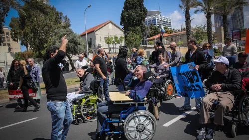 Disabled veteran Israel Defense Forces soldiers and their assistants protest outside the Defense Ministry in Tel Aviv, on March 29, 2016. Photo by Yossi Zamir/Flash90.