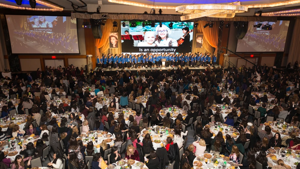 Chabad girls from around the world, who were present at programs of their own during the conference, performed at the gala banquet. Credit: Chavi Konikov.