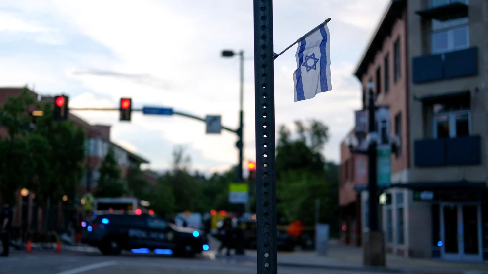 An Israeli flag is fixed to a street sign as police stand by off Pearl Street at the scene of an attack on demonstrators calling for the release of Israeli hostages held in Gaza, in Boulder, Colorado, on June 1, 2025. Credit: Eli Imadali/AFP via Getty Images.