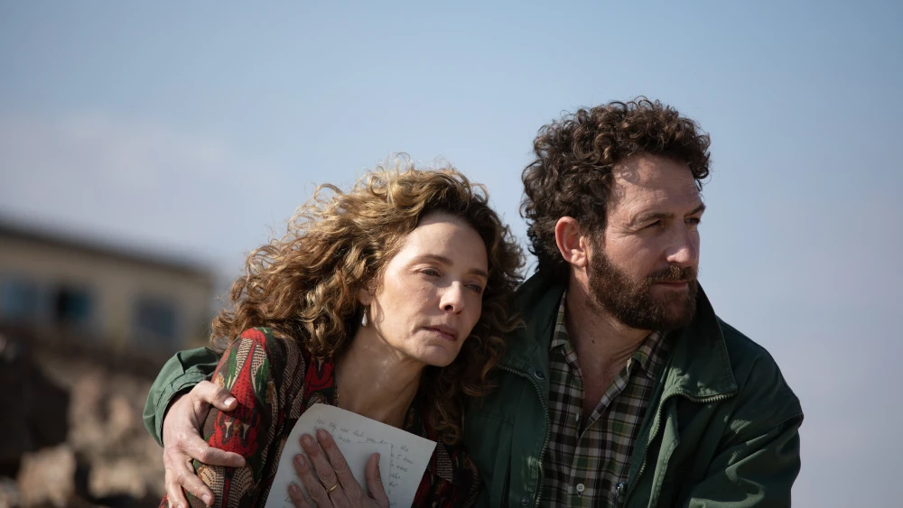 The characters Esther Horwitz (played by Mili Avital) and Zayde Rabinovich (played by Ori Pfeffer) in the Hebrew-English 2025 film “For the Love of a Woman.” Photo by Vered Adir ©2023 Colorado Film Production, Vivo Film.