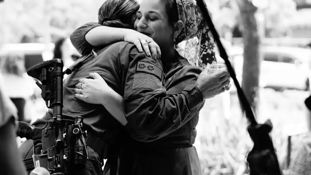 Hadassa Ben Ari (right), the head of "The Heroes of October 7th: Heroic Stories for Children" project, embraces a hero. Credit: Courtesy.