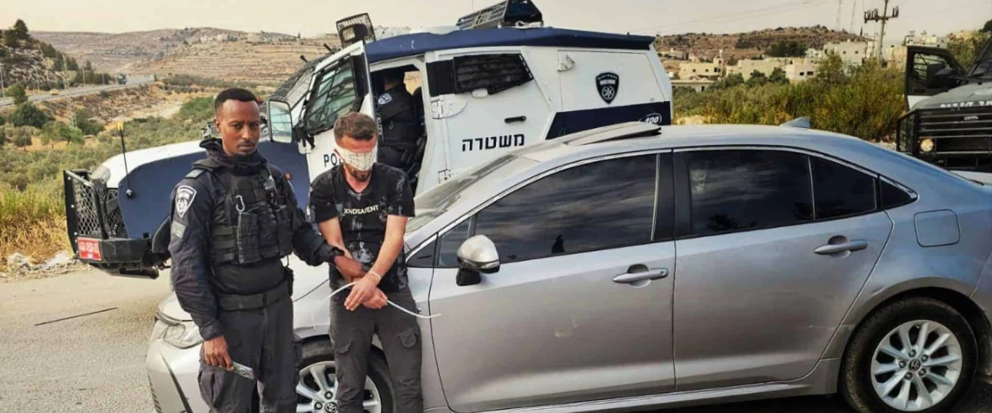 An Israeli police officer detains a Palestinian suspect in an undisclosed location in Judea and Samaria, as part of the law enforcement operation “Stopping at Red,” carried out in August, 2025. Credit: Israel Police.