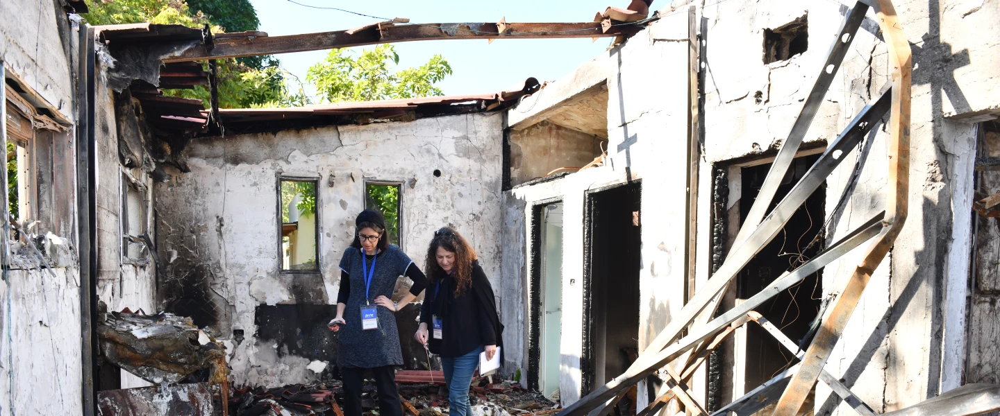 Dr. Nirit Shalev-Khalifa and Dina Grossman from Jerusalem's Yad Ben-Zvi Institute scour Kibbutz Re'im following the Oct. 7, 2023, Hamas massacre. Photo by Sarit Uzieli.