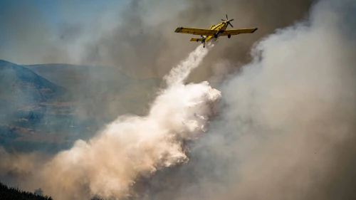 A firefighting plane tries to extinguish a wildfire following a missile attack from Lebanon, near Kibbutz Ayelet HaShahar, northern Israel, Aug. 17, 2024. Photo by Ayal Margolin/Flash90.