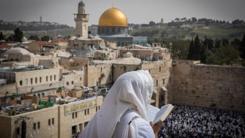 A man covers himself with a prayer shawl while praying near the Western Wall in Jerusalem's Old City, January 2019. Credit: Yonatan Sindel/Flash90.