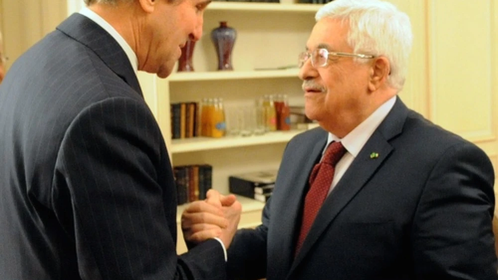 U.S. Secretary of State John Kerry and Palestinian Authority leader Mahmoud Abbas shake hands before a meeting in Paris on Feb. 19, 2014. Credit: U.S. State Department.