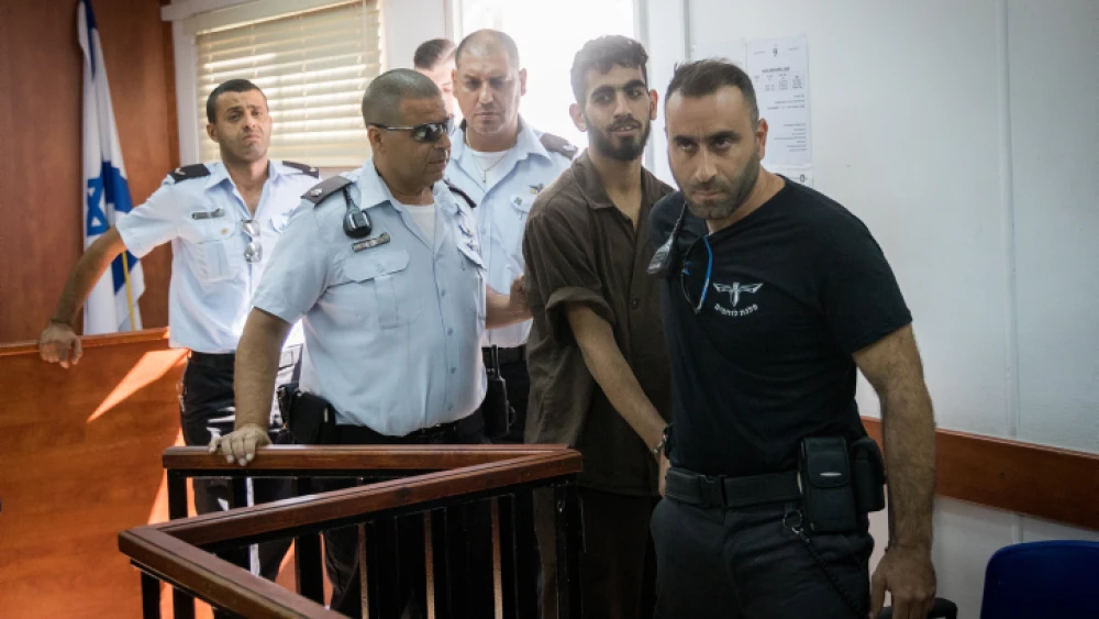 Omar Al-abed is brought to the courtroom for his trial at the Israel's Ofer military court near the West Bank city of Ramallah on Aug. 17, 2017. Alabed was detained after committing a deadly stabbing terror attack, killing Yosef Salomon (70), his daughter Haya (46) and son Elad (35) at their home in the Jewish settlement of Halamish. Photo by Yonatan Sindel/Flash90