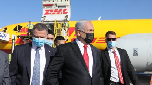 Israeli Prime Minister Benjamin Netanyahu and Health Minister Yuli Edelstein attend the arrival at Ben-Gurion International Airport of the DHL cargo jet bearing the first batch of Pfizer-BioNTech COVID-19 vaccines, Dec. 9 2020. Photo by Marc Israel Sellem/POOL.