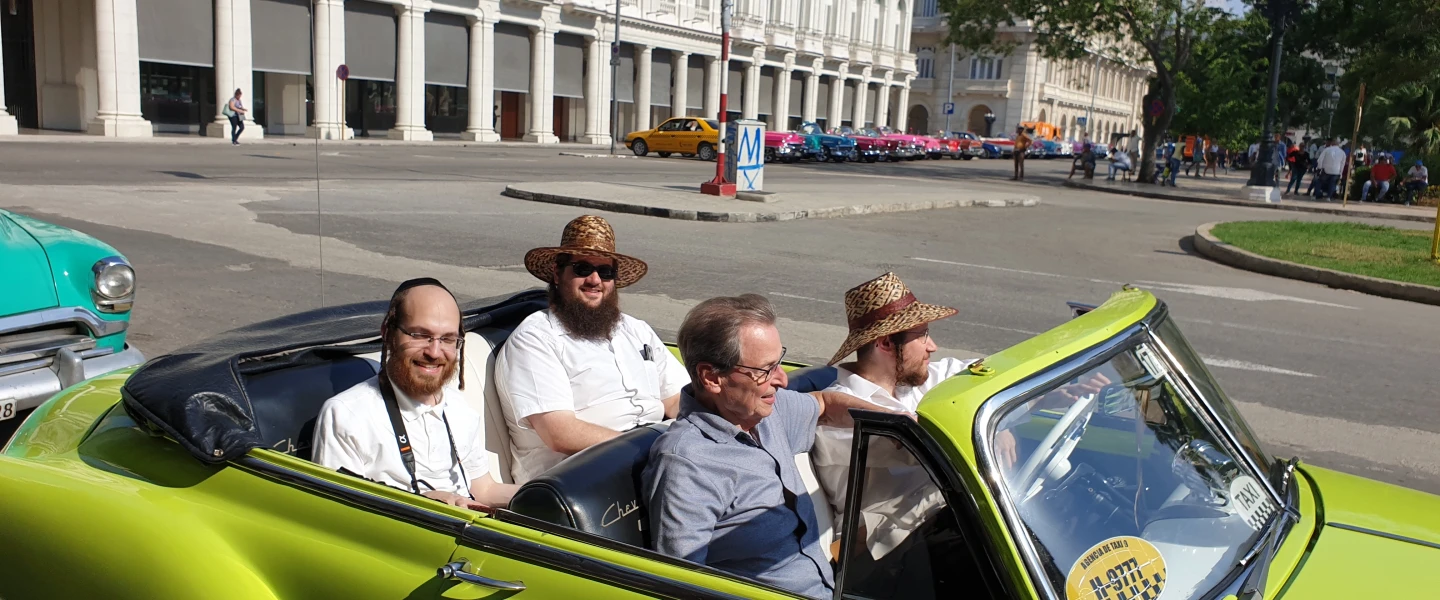 Saul Berenthal (front left), 75, was born and raised in Cuba but left for Miami in 1960, following the 1959 Castro revolution. He is pictured here in Havana, cruising around in a classic 1950s American-made car. Credit: Courtesy.
