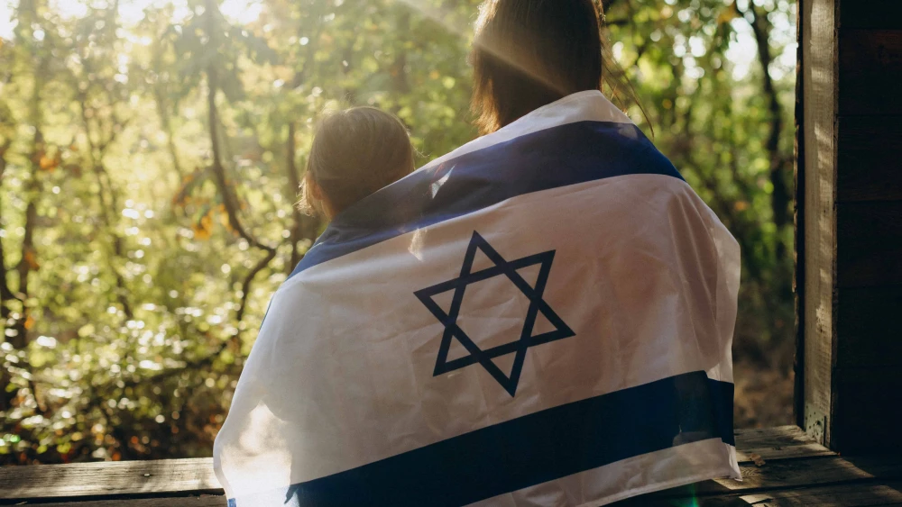 An image of sisters draped in the Israeli flag. Source: Pazargic Liviu/Shutterstock